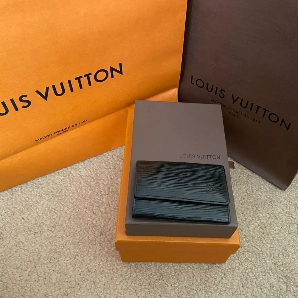 Auth LV black epi key fob is A+‎ condition. Matching wallet and bag available